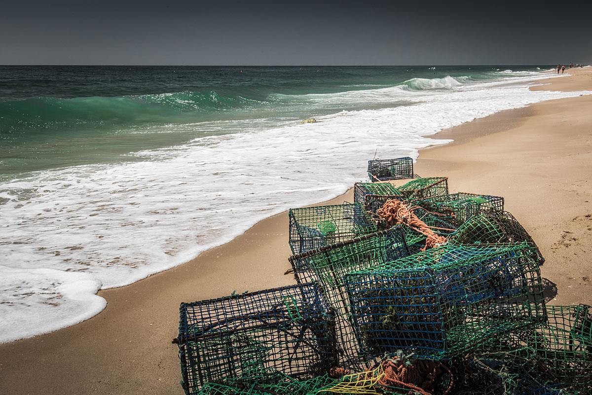 Traditional Gaiolas de Polvo (octopus traps) lying on the sandy shore of Ria Formosa, patiently awaiting the next fishing expedition.
