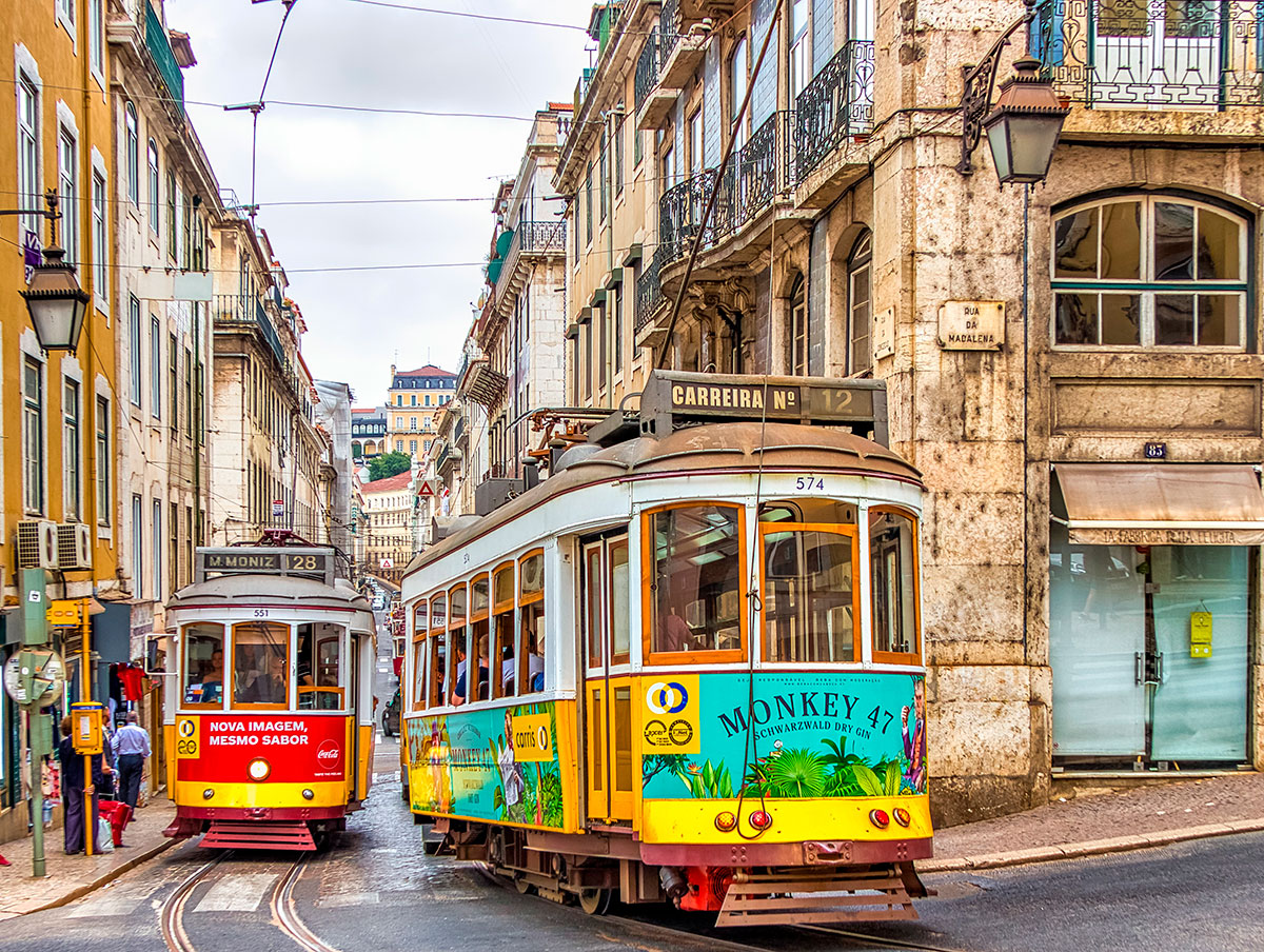 Historic Tram 28 navigating Lisbon's streets.