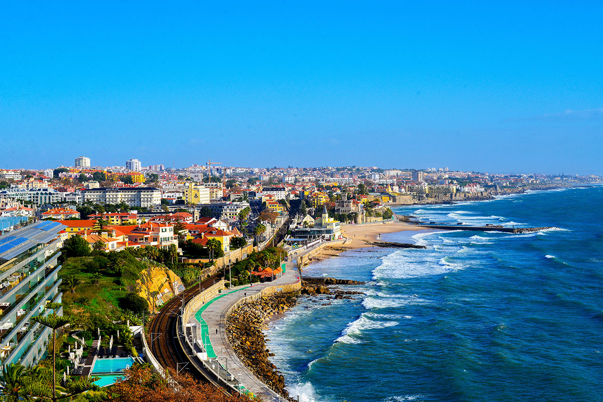 Aerial view of Cascais coastline with beaches, marina, and town buildings