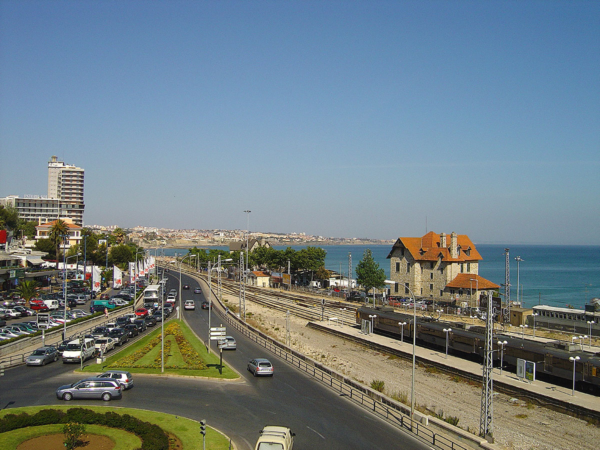 Train arriving at Cascais station with ocean in the background