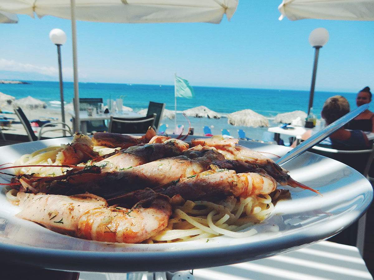Grilled seafood dish served with wine near the coast