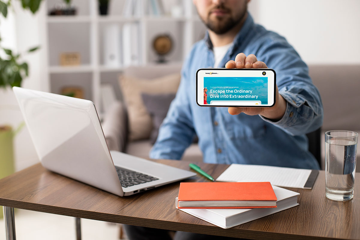 A person using a laptop to book a travel experience online, with a website open displaying tour options and destination images.