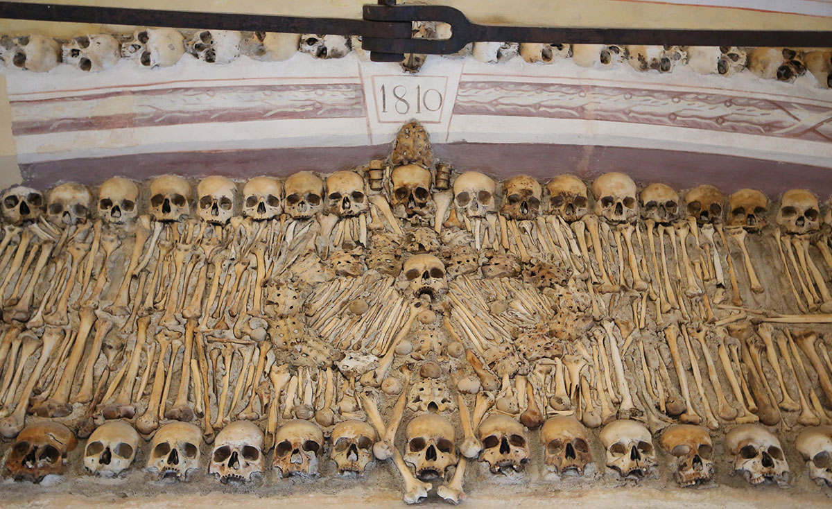 Human skulls and bones meticulously arranged inside the Chapel of Bones.