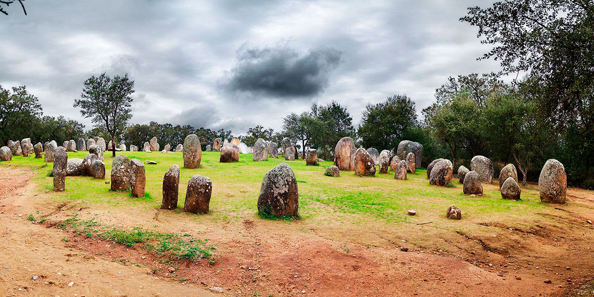 Ancient standing stones of the Almendres Cromlech glowing in the early morning sun.