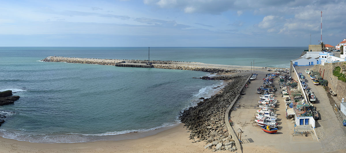 Colorful traditional fishing boats docked in Ericeira harbor