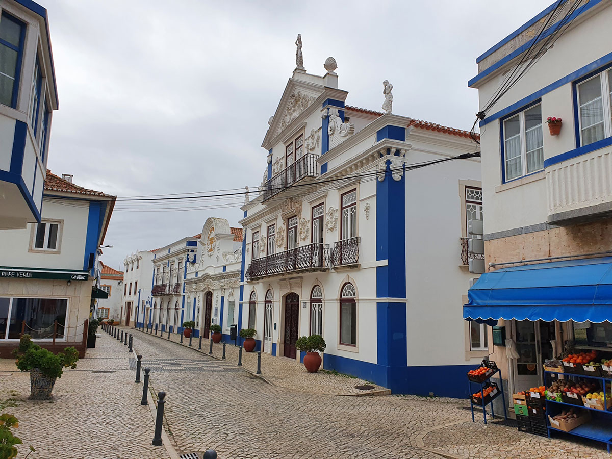 Charming cobblestone street lined with whitewashed houses in Ericeira