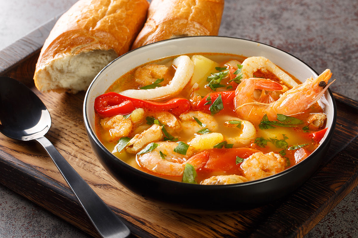 A bowl of traditional Portuguese fish stew (Caldeirada) with assorted seafood