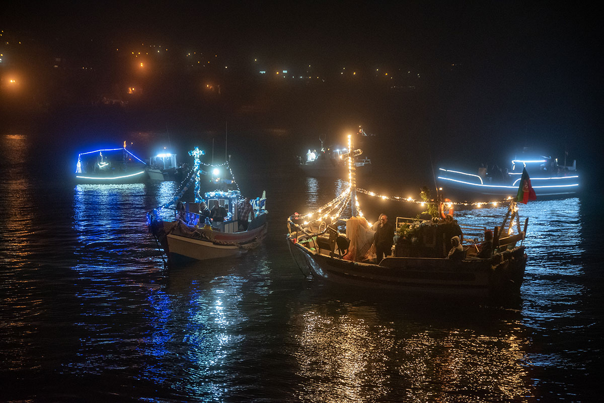 Nighttime celebration with illuminated decorations during the Nossa Senhora da Boa Viagem festival in Ericeira