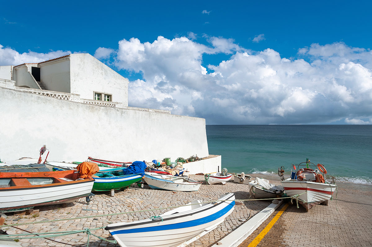 Whitewashed fisherman’s cottage with blue accents in Burgau