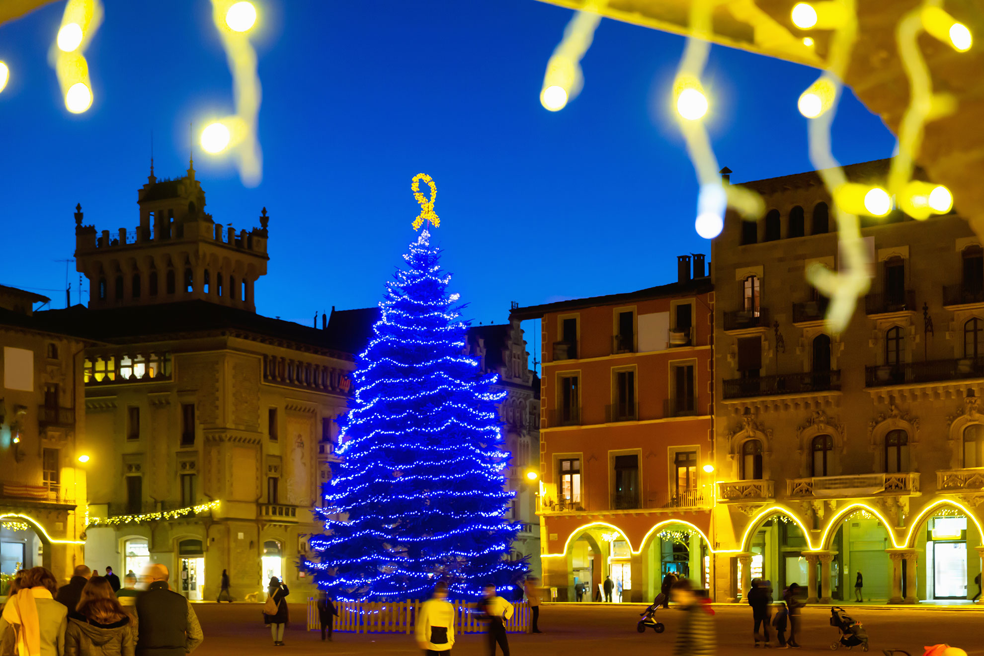 Illuminated streets of old town of Spanish Vic city festively decorated for Christmas