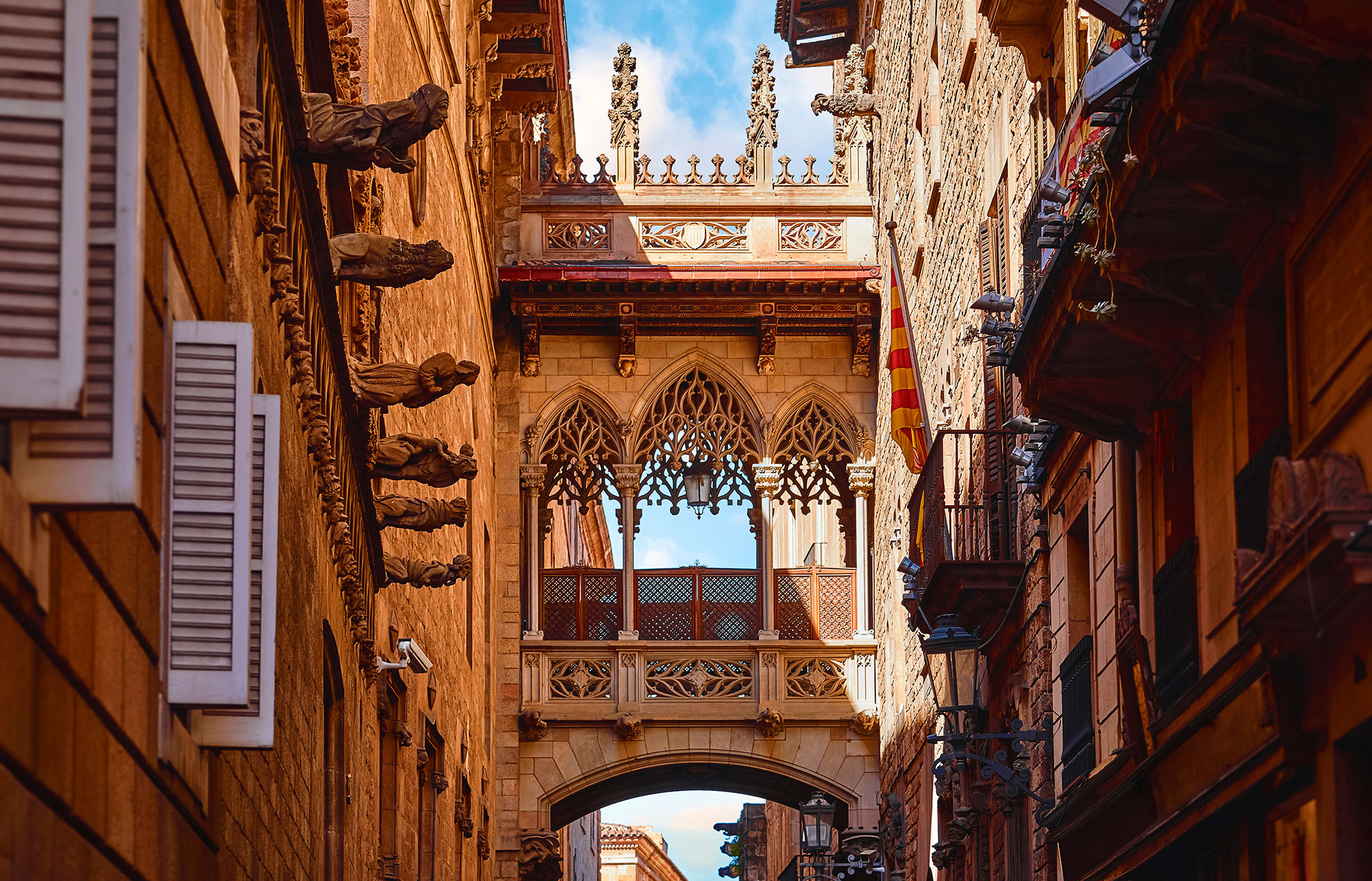 Barri Gotic Quarter in Barcelona, Spain. Antique Bridge between stone walls of medieval buildings in in old town. Famous touristic landmark and travel destination.