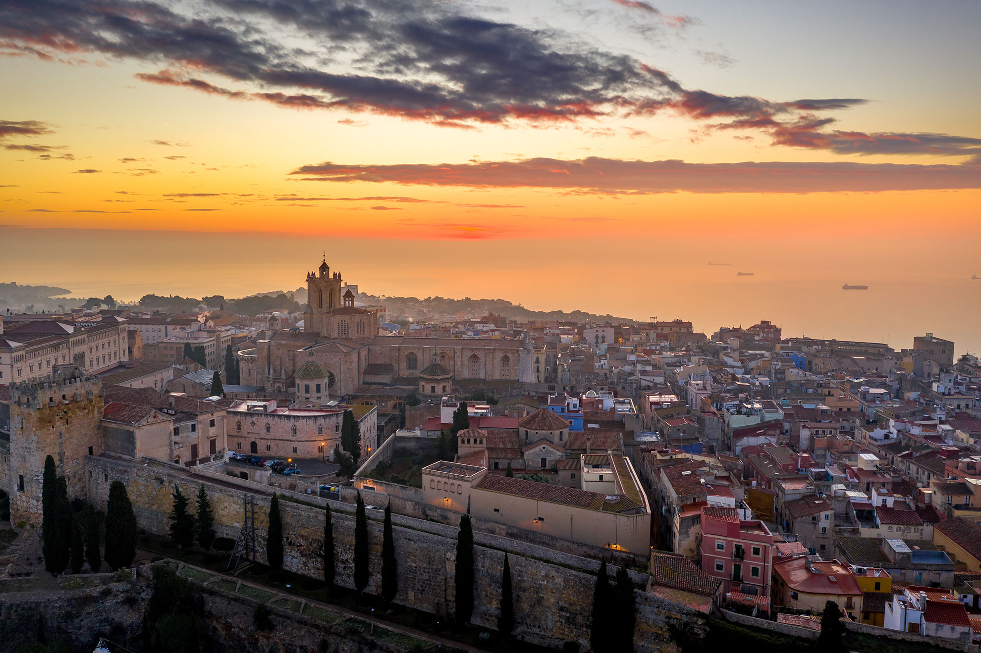 Aerial sunrise view of the medieval walled center of Tarragona in Catalunya Spain with the cathedral, city walls, bastions and towers 