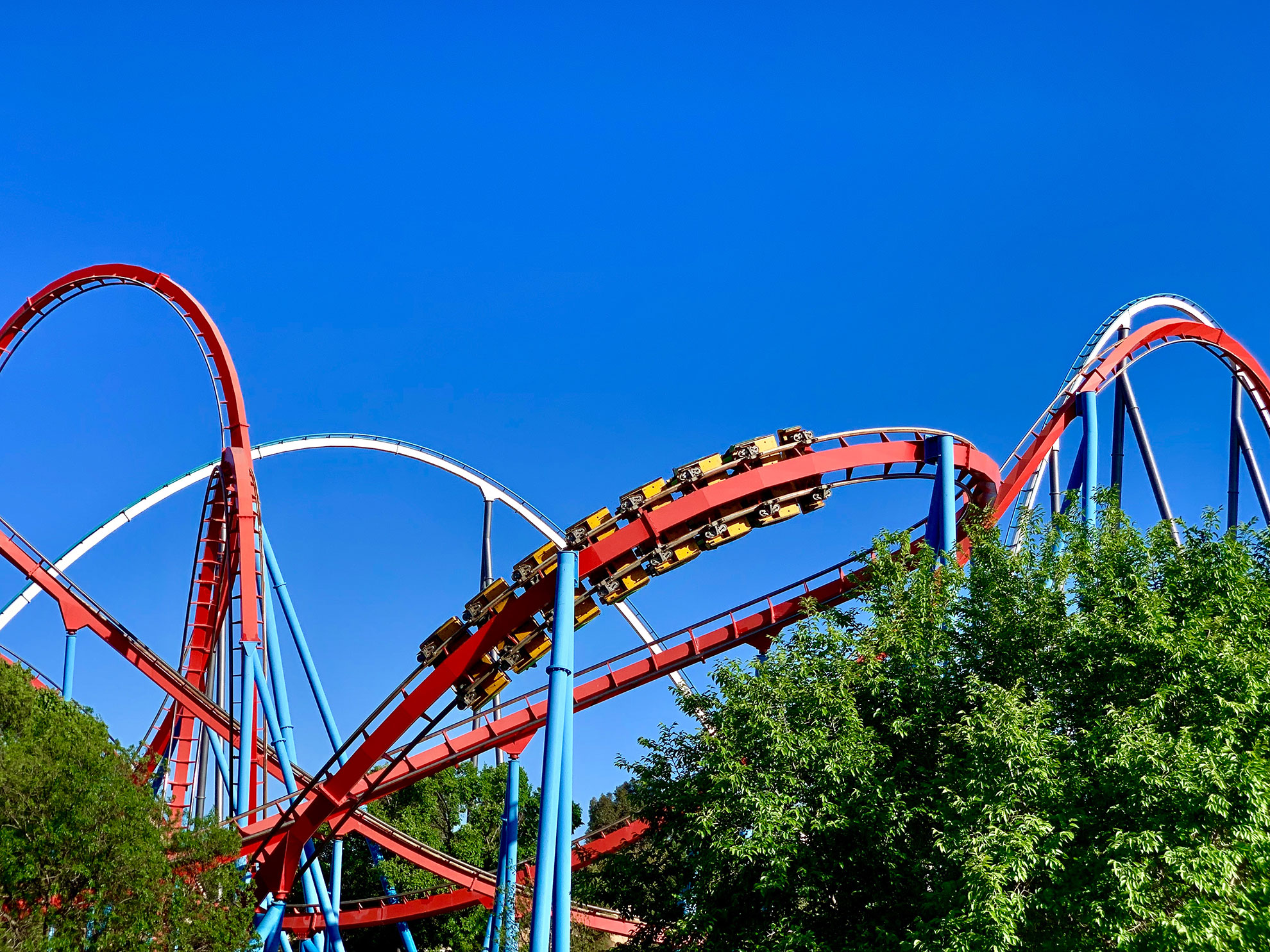 Portaventura World. A red roller coaster in a amusement park with some loopings