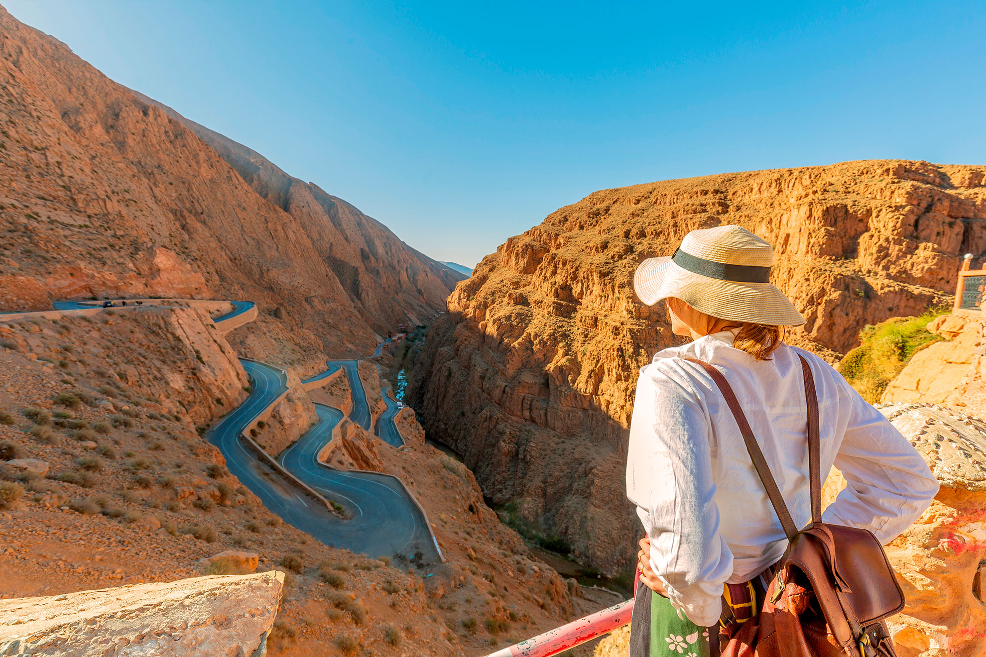 Young tourist looking at the dades gorge road. is a gorge of the Dades River in the Atlas Mountains of Morocco. The depth of the Dades gorge is from 200 to 500 meters.