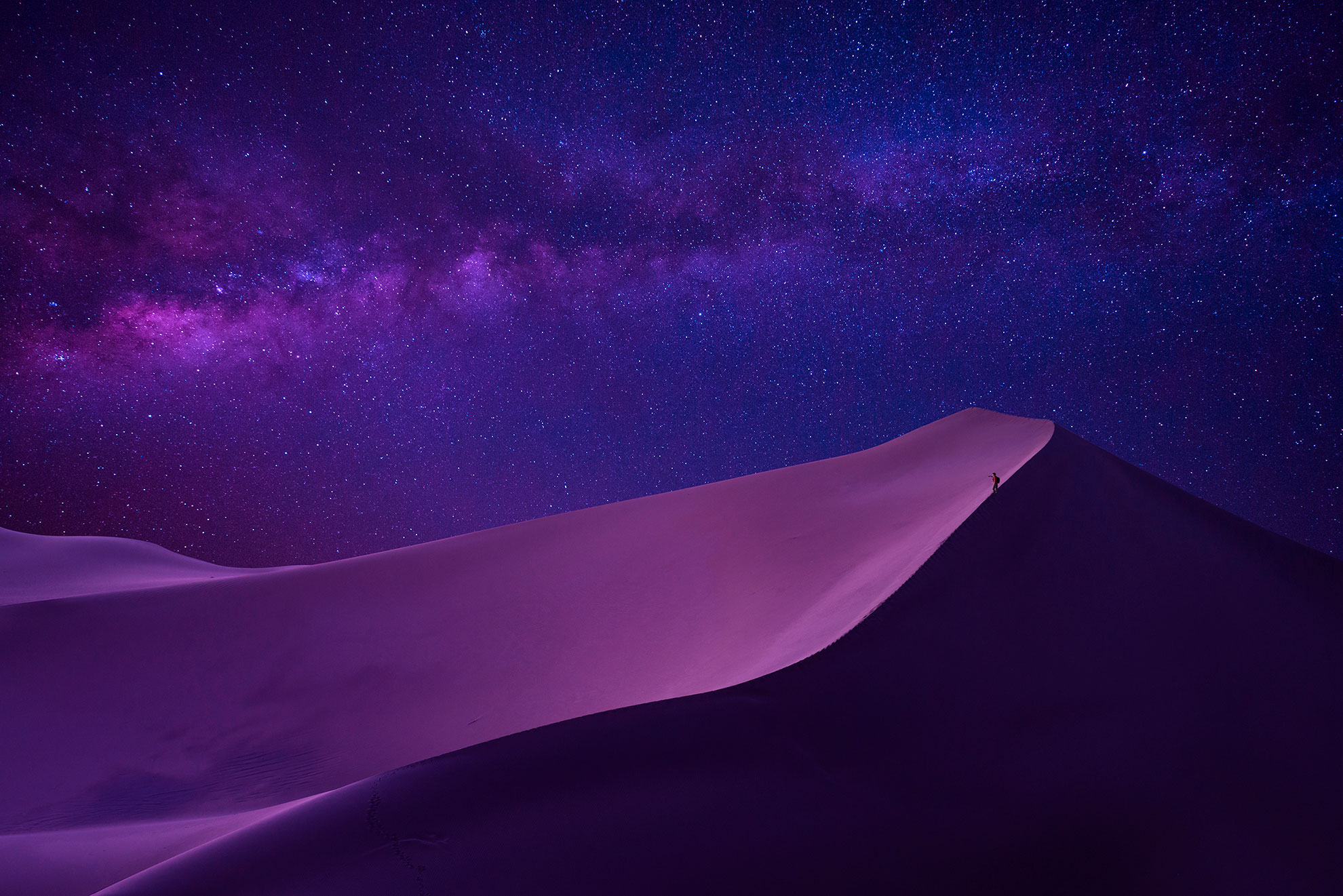 man looking milky way in desert 