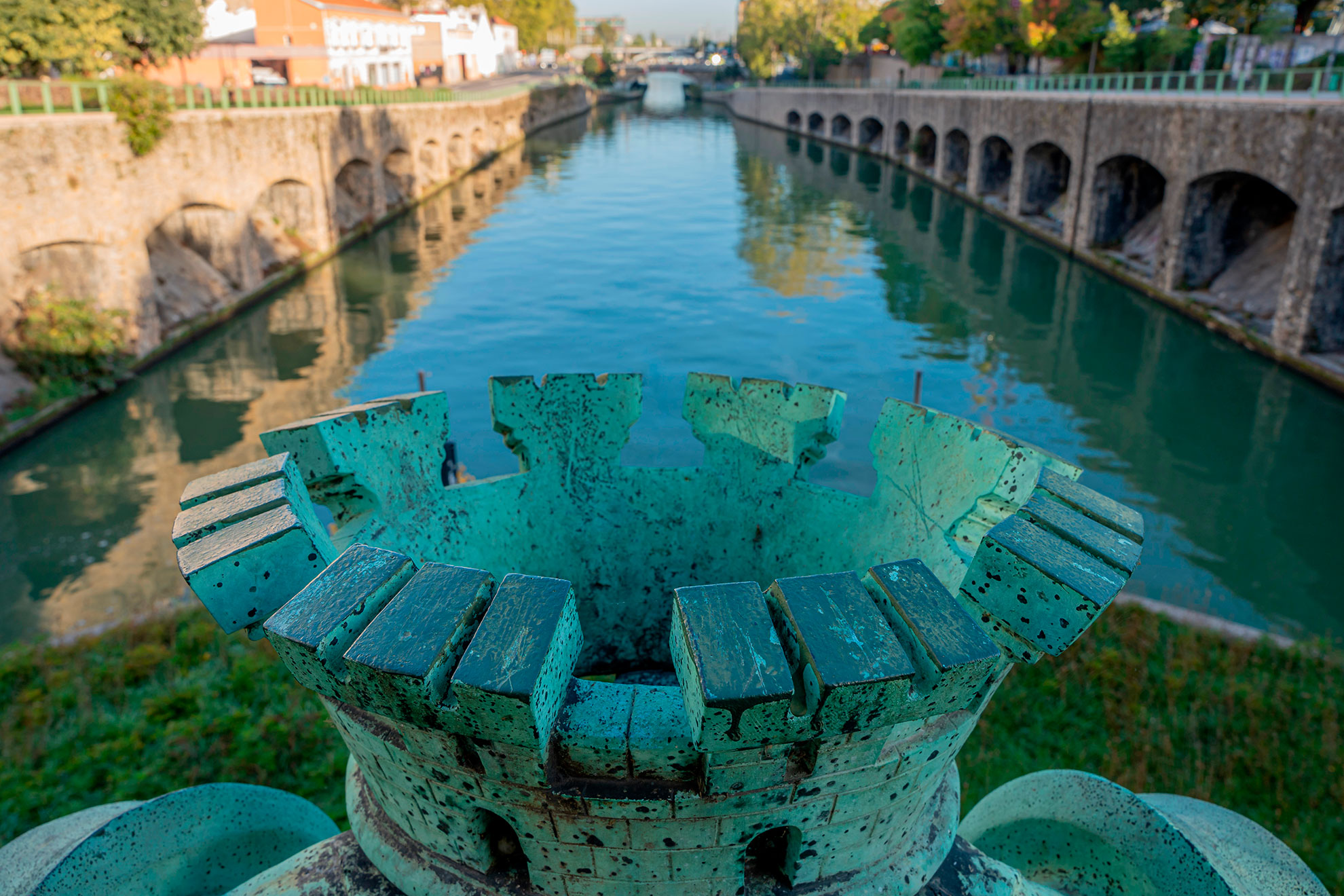 Reflections on the Saint-Denis Canal, a train on a bridge from Flanders Bridge Lock reflecting