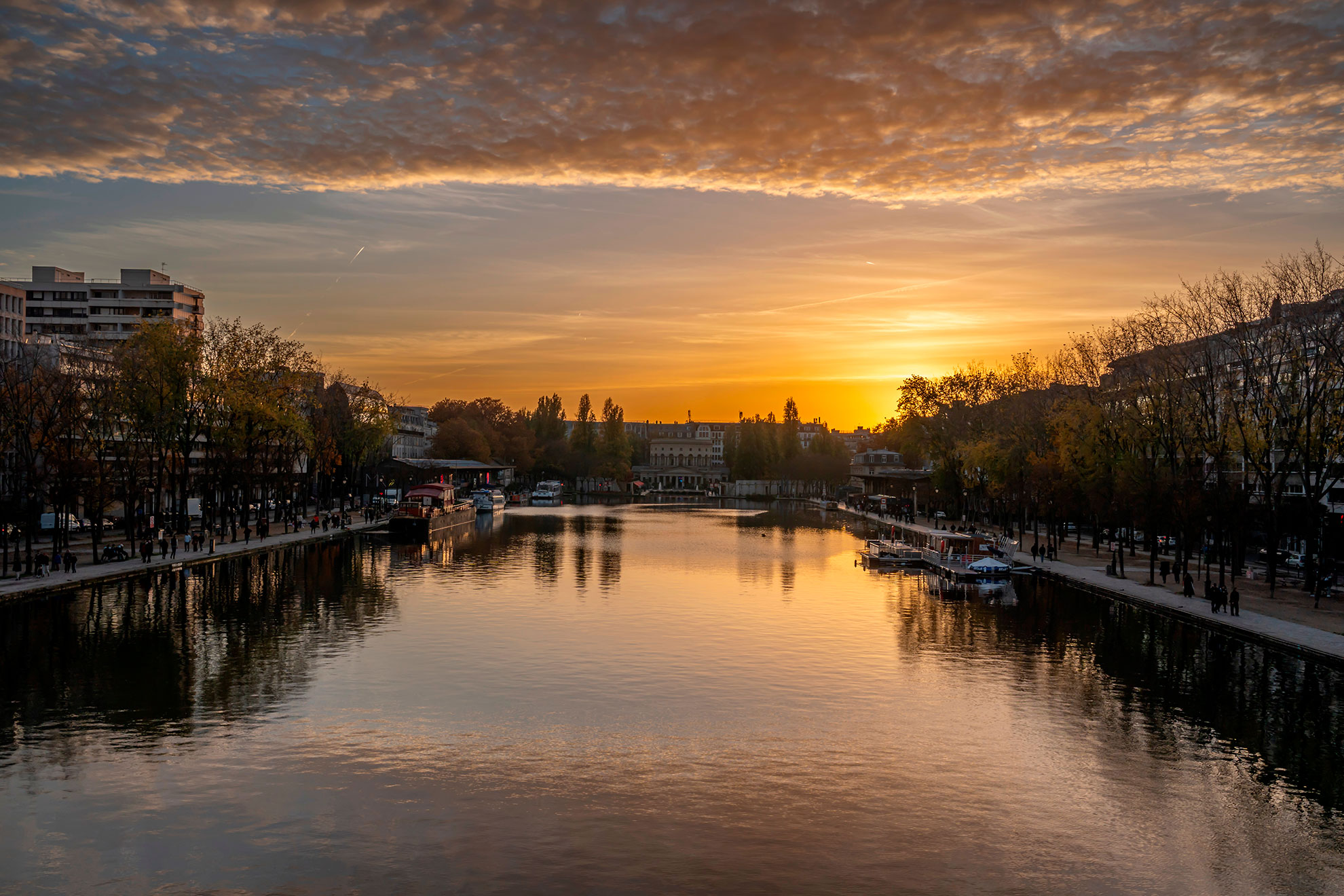 Ourcq Canal. Panoramic View of the Villette Basin and buildings around at sunset and golden hour 