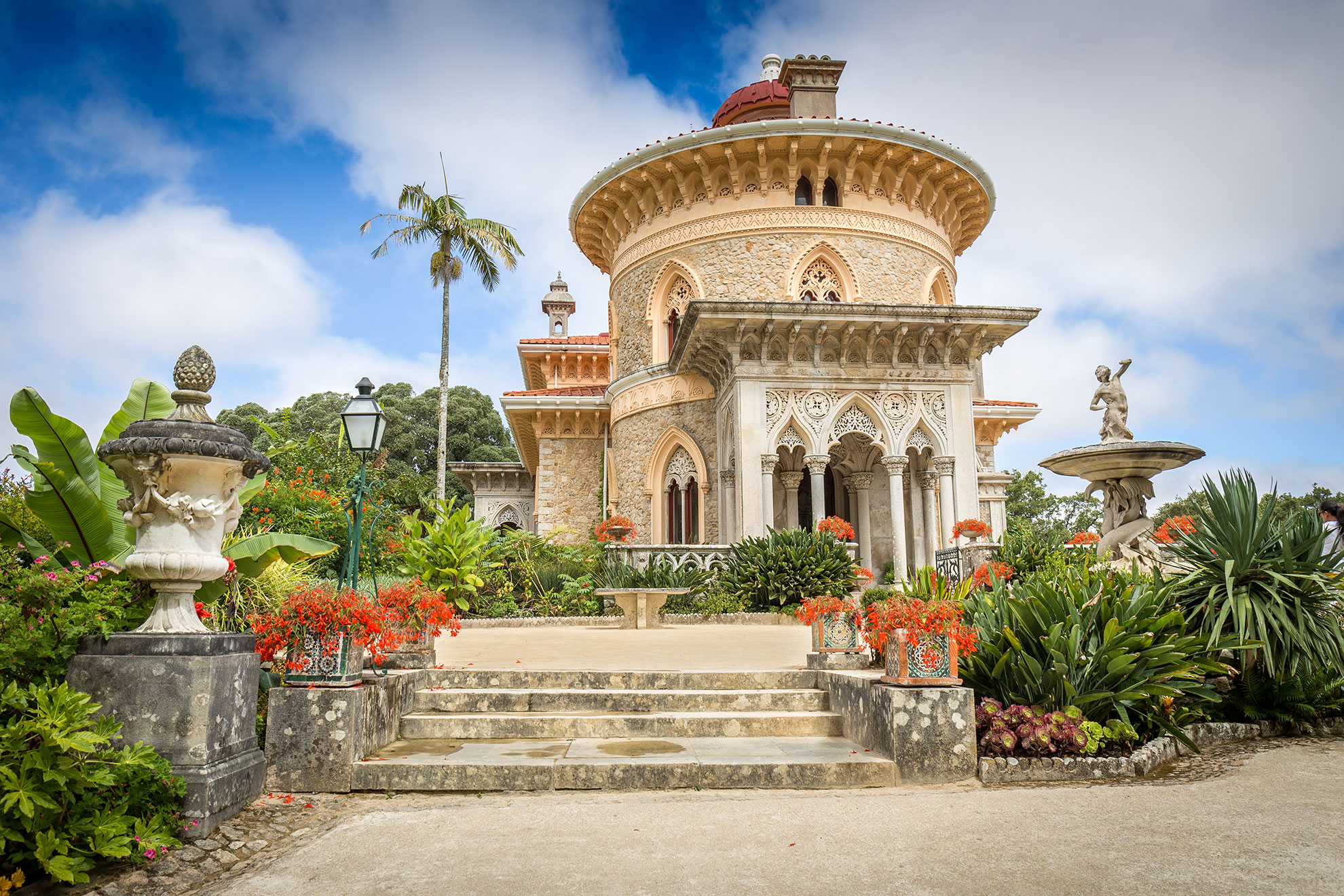 Palácio de Monserrate ornate Moorish-Gothic facade surrounded by tropical gardens and sculptures in Sintra, Portugal