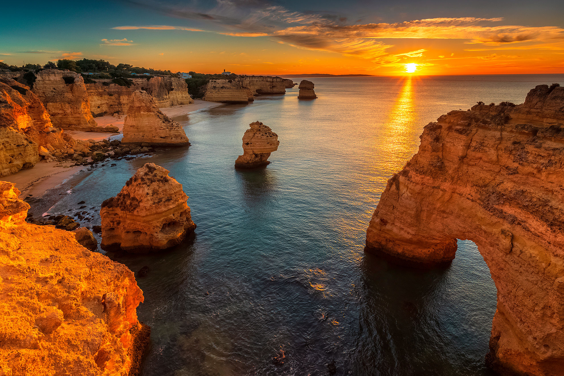 Sunset at Praia da Marinha, Algarve — golden limestone cliffs and clear turquoise water, one of Portugal's most beautiful beaches