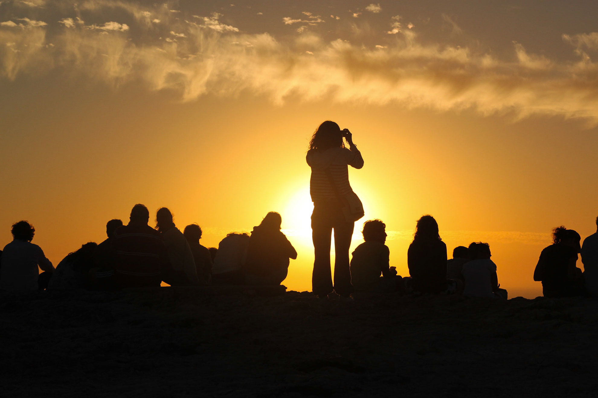 Group of tourists watching the sunset at Cabo de São Vicente, Sagres, Algarve, Portugal