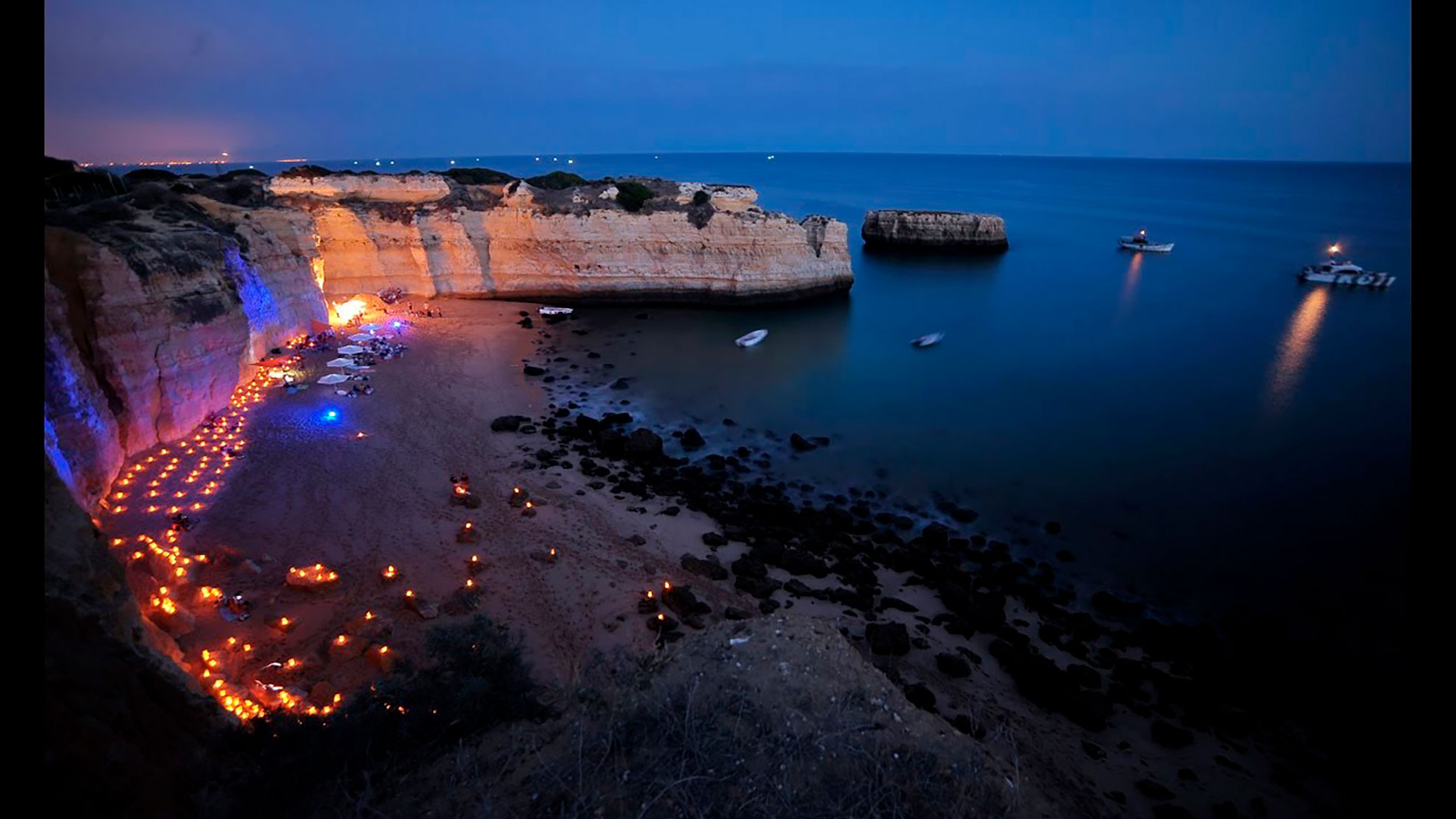 Beach barbecue at sunset in Albufeira, Algarve — group celebration by the sea in the evening