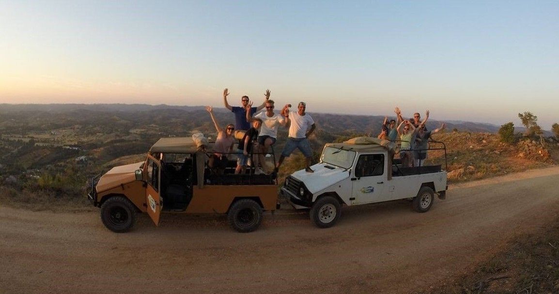 Group of tourists enjoying a jeep safari tour through the Algarve countryside