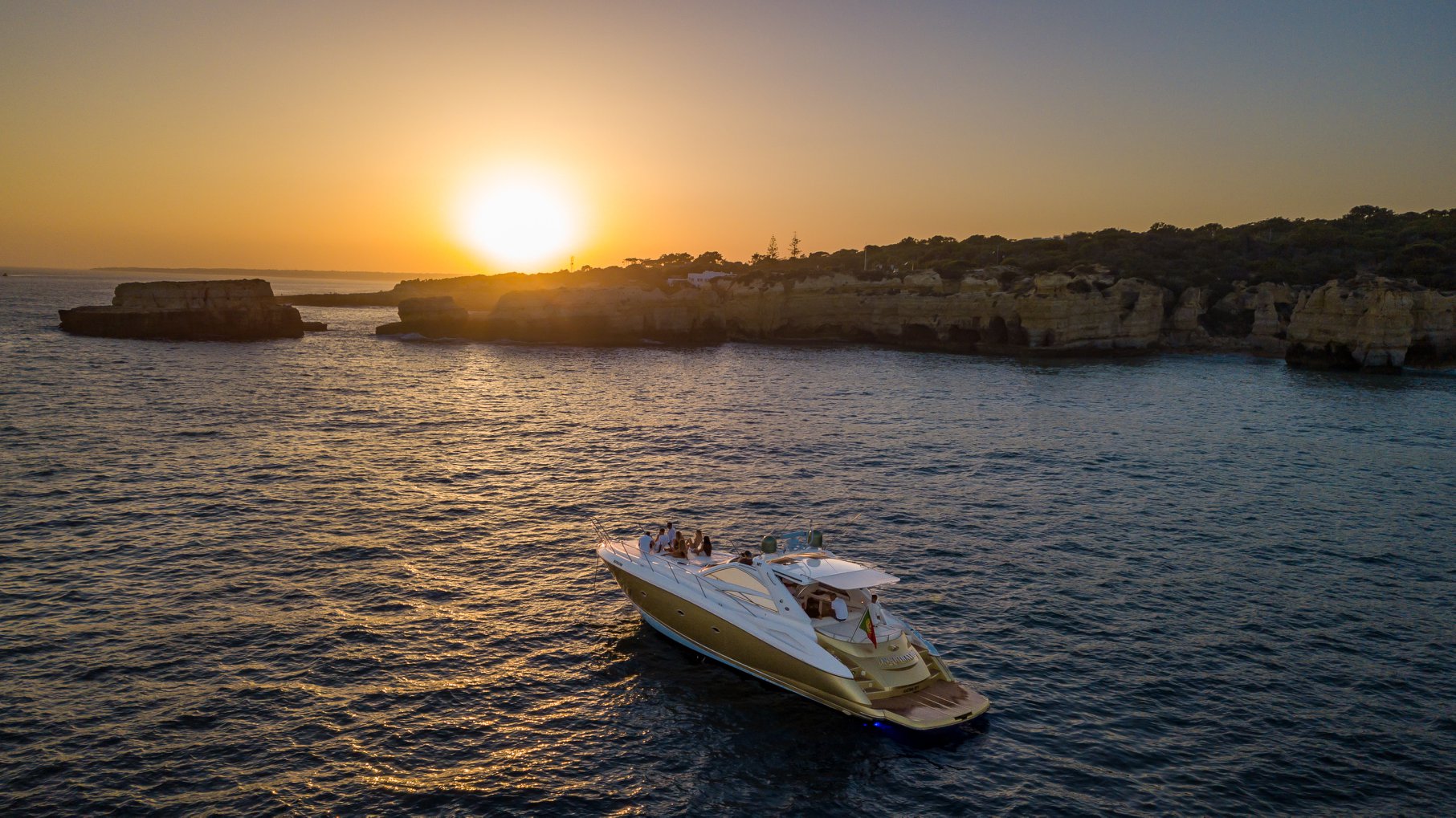 Boat tour along the Algarve coastline with golden cliffs and turquoise Atlantic waters