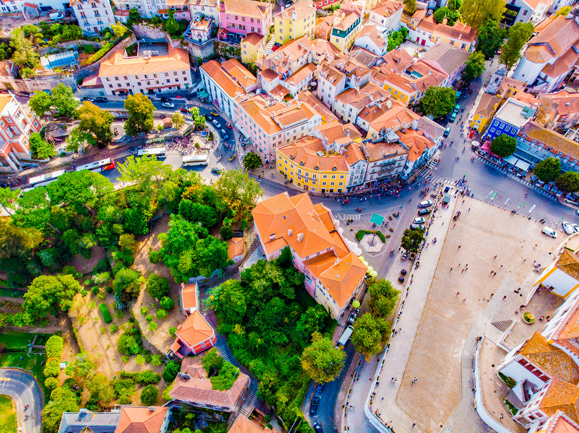 The colourful facades of Sintra's Pena Palace seen through pine trees