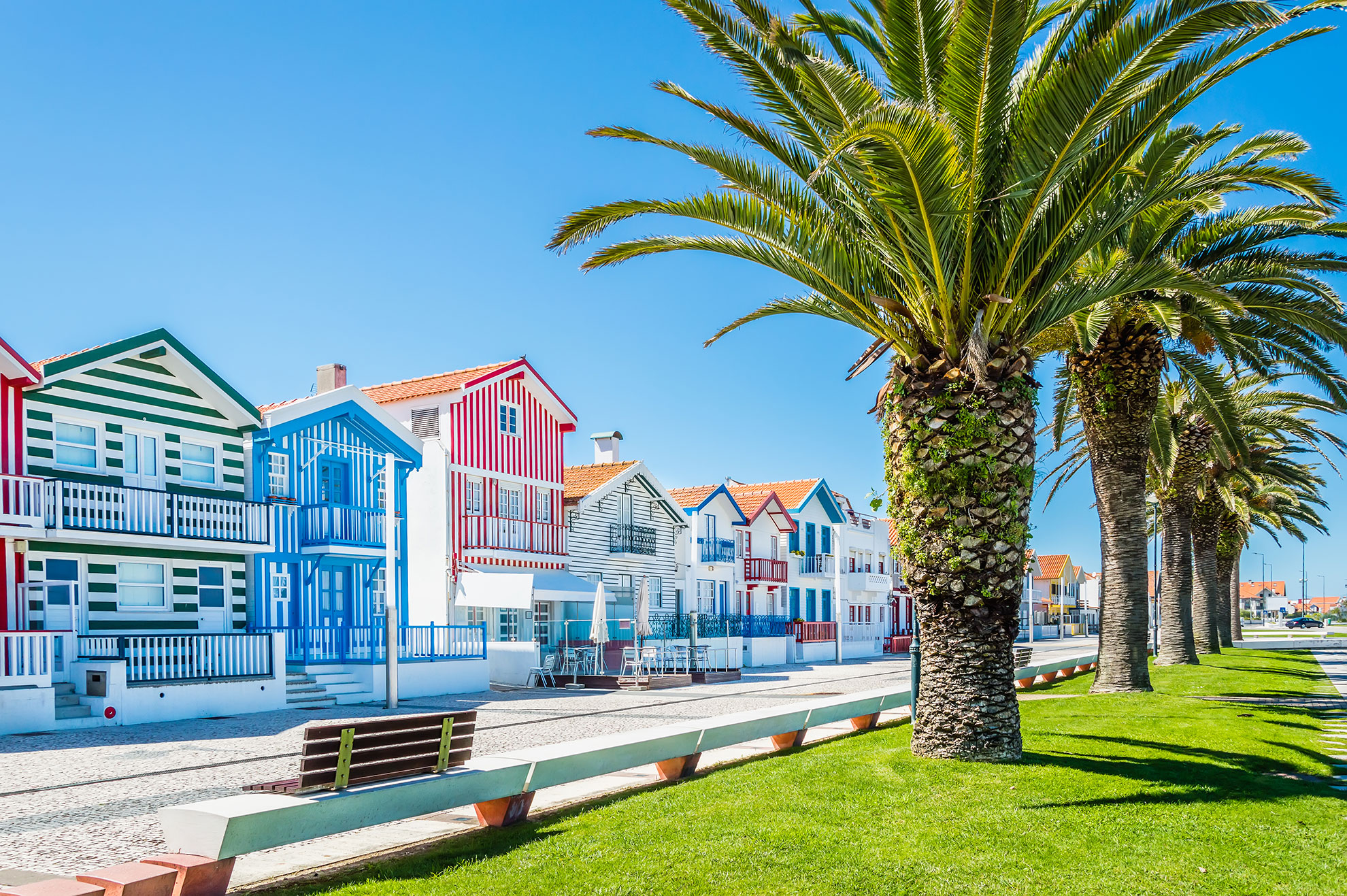 Candy-striped Palheiros fishing cottages at Costa Nova with the Atlantic in the background