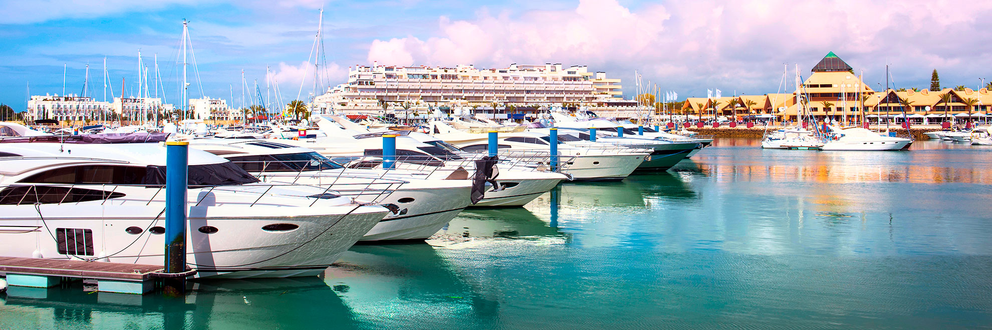 Vilamoura Marina with luxury yachts moored along the quay at golden hour