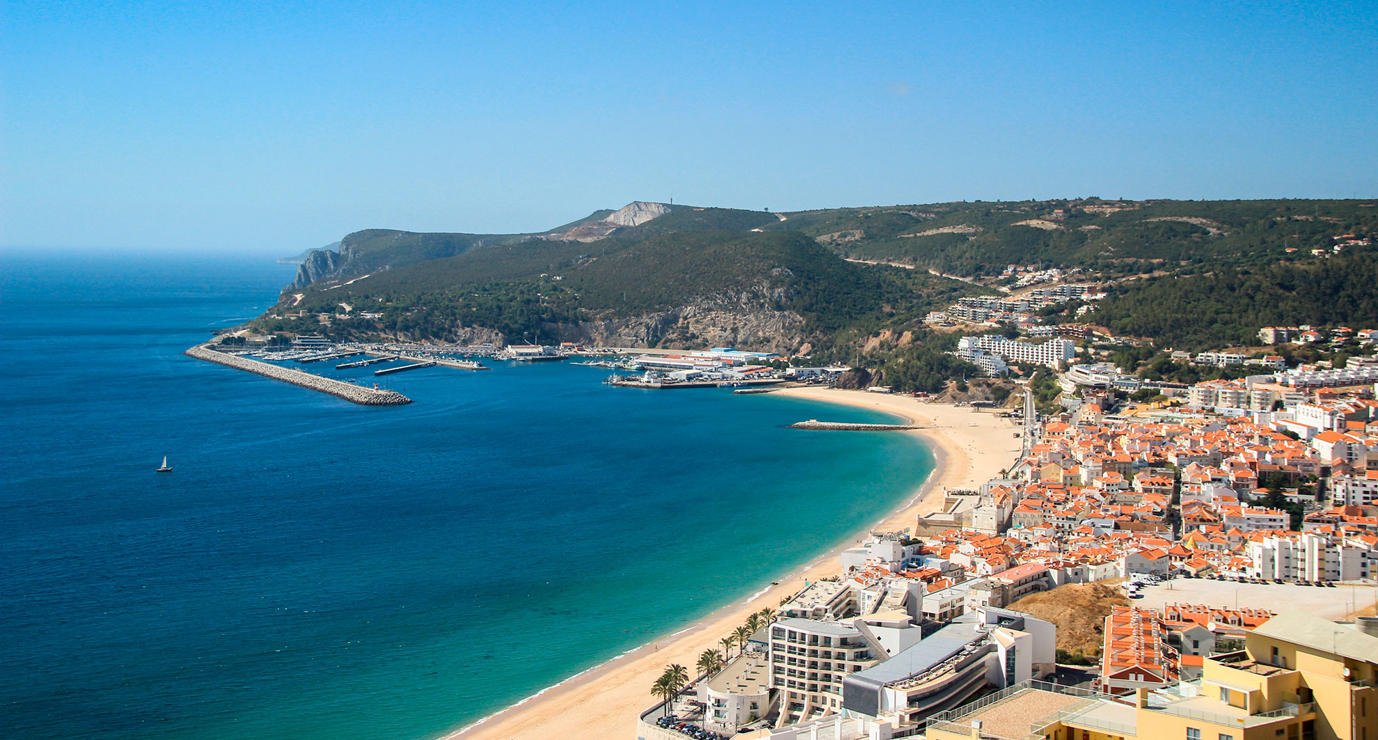 Sesimbra's sheltered bay with the Moorish castle overlooking turquoise waters