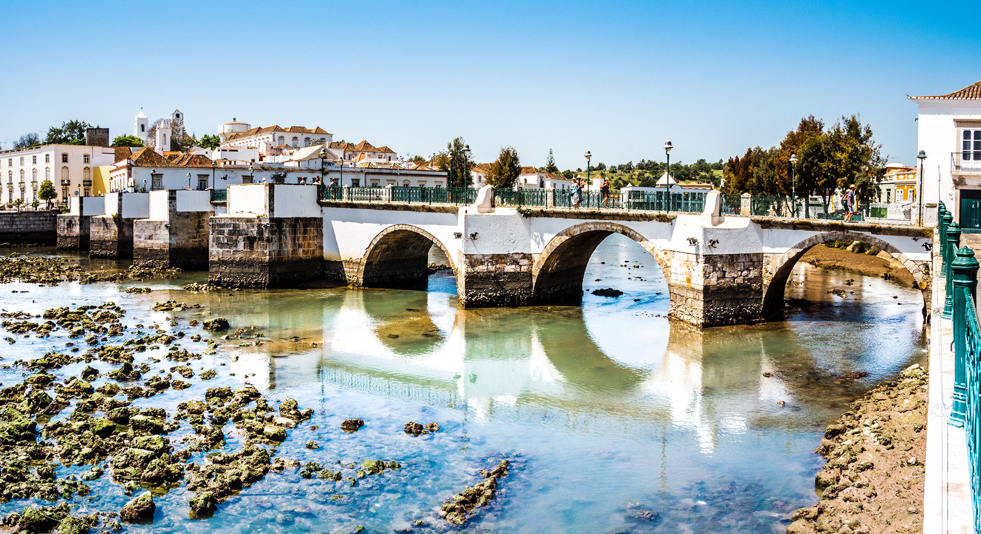 The Gilão River and Roman Bridge in Tavira at golden hour