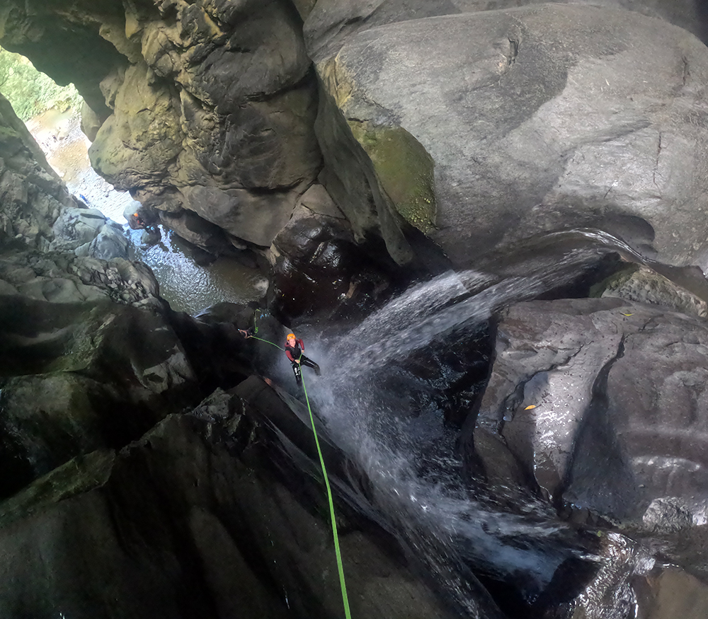 Canyoning through a mossy ravine in São Miguel, Azores