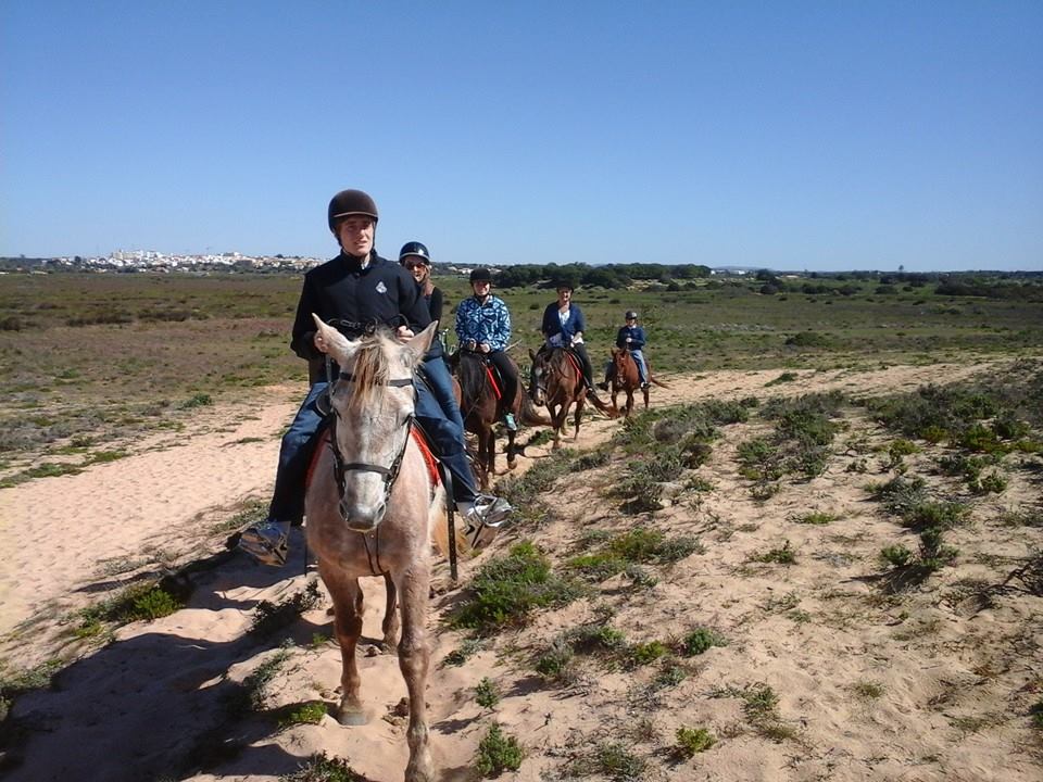 Guided rider following the lagoon-side trail at Lagoa dos Salgados