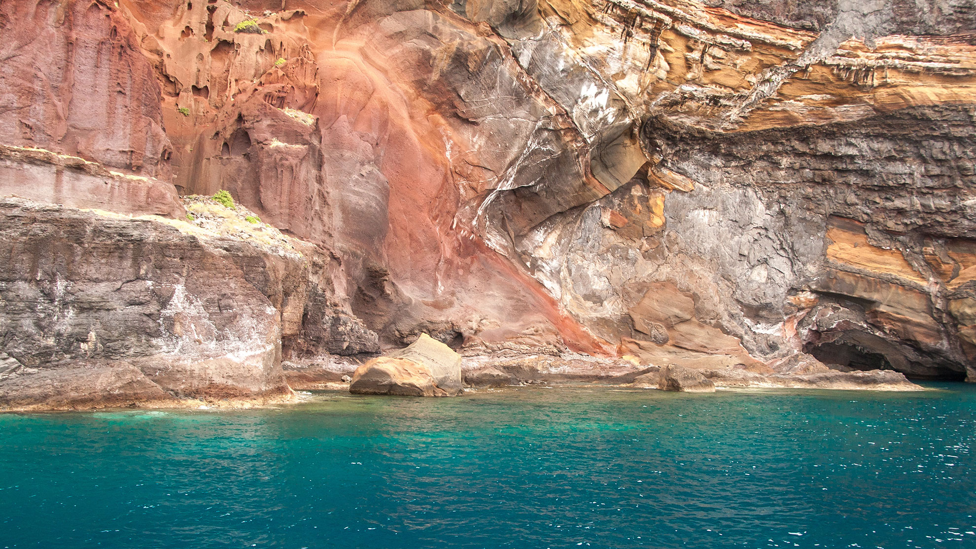 The rugged obsidian cliffs of the Desertas Islands rising from the Atlantic
