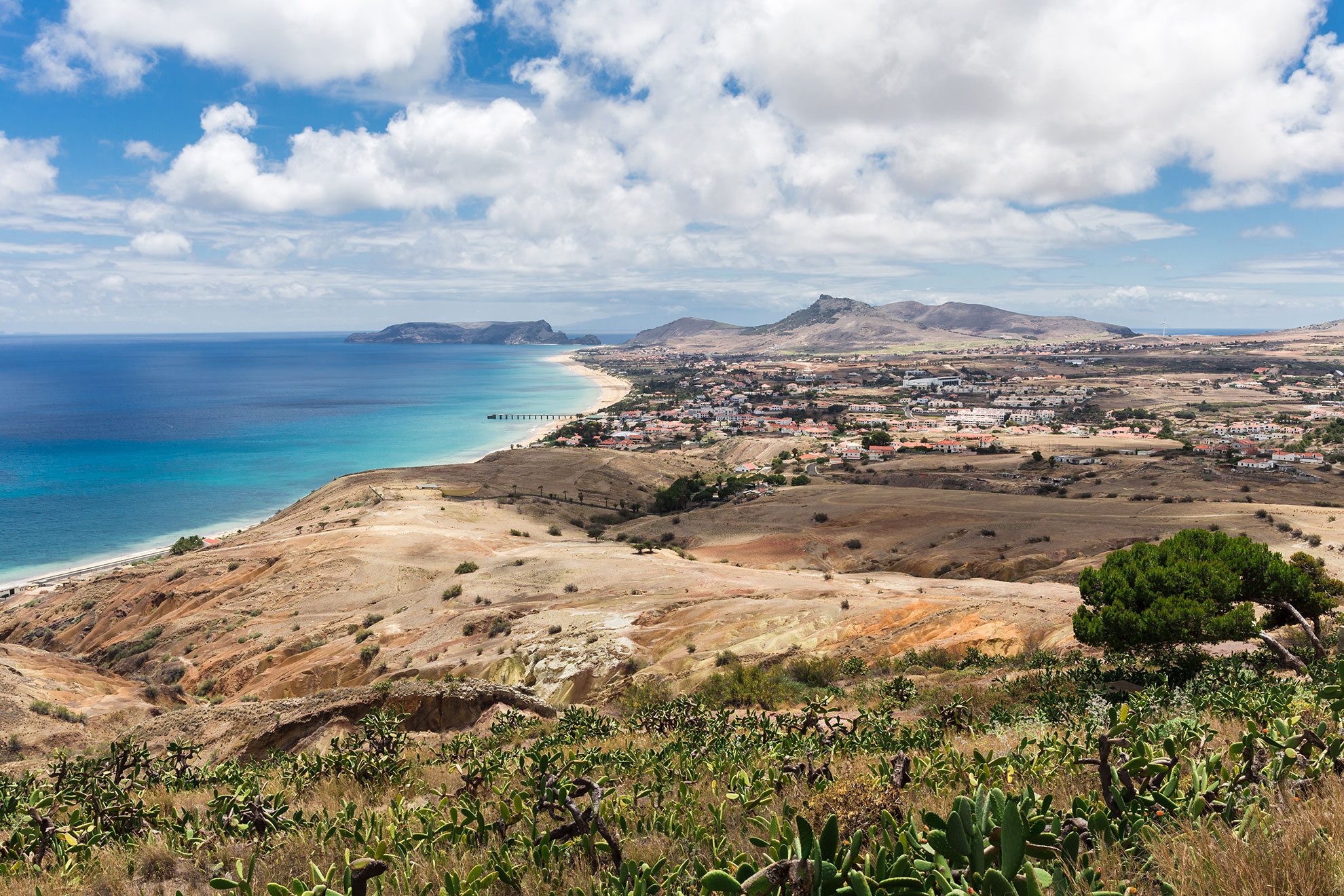 View from Portela viewpoint across Porto Santo's interior landscape toward the golden beach