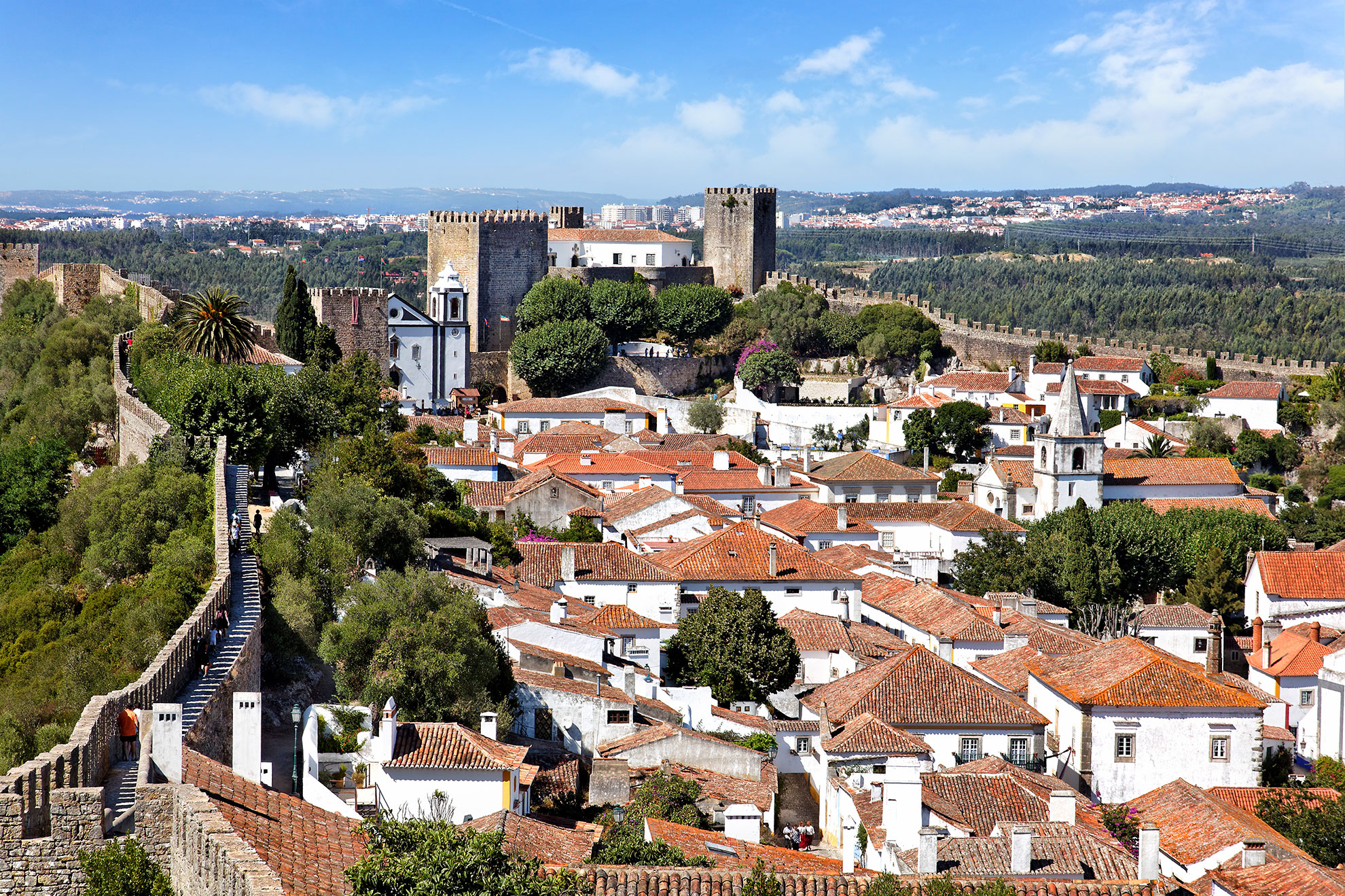 Panoramic view of the walled village of Óbidos with its crenelated castle walls and whitewashed houses