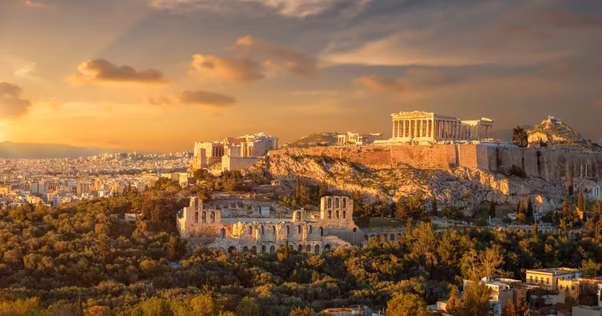 The Parthenon and Acropolis of Athens seen from below against a blue Greek sky