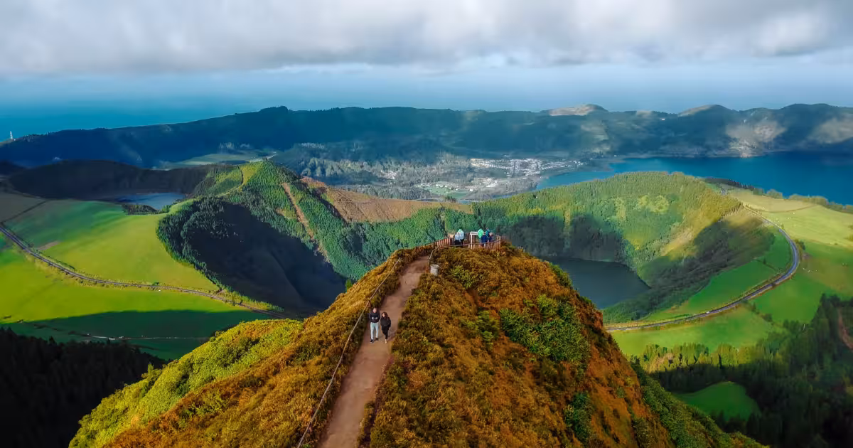 Couple watching sunset over twin lakes of Sete Cidades crater S&atilde;o Miguel Azores