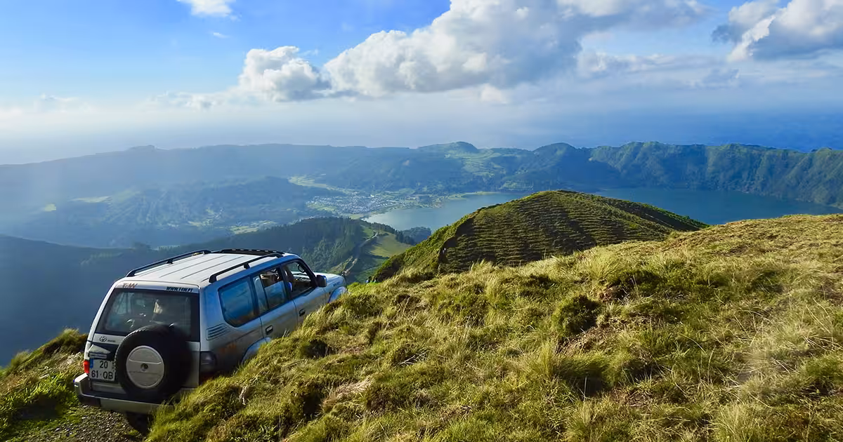 Jeep climbing a steep basaltic track above a volcanic crater in S&atilde;o Miguel Azores