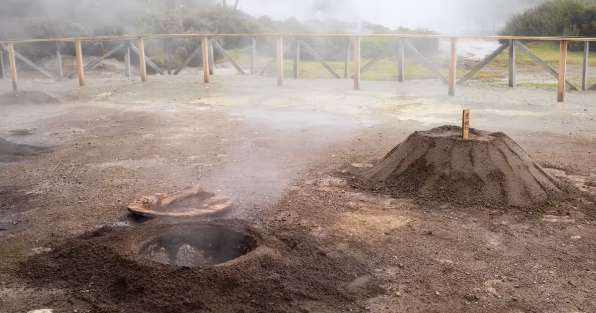 Burlap sacks of Cozido das Furnas being unearthed from volcanic soil at Lagoa das Furnas