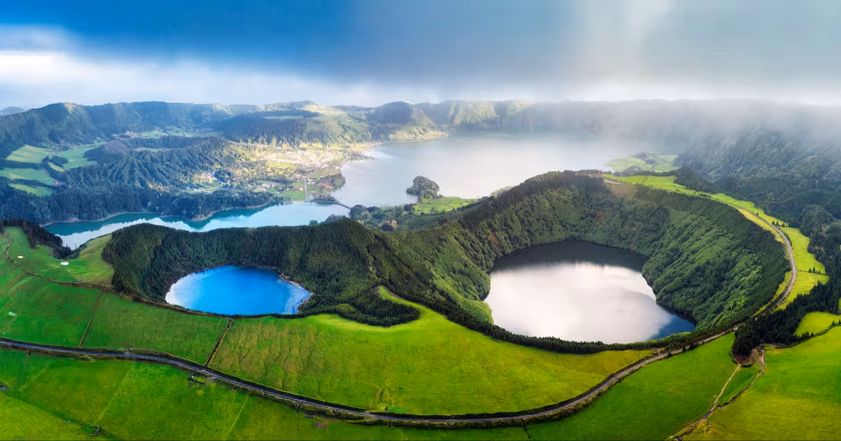Emerald crater lake of Sete Cidades beneath clearing clouds S&atilde;o Miguel Azores