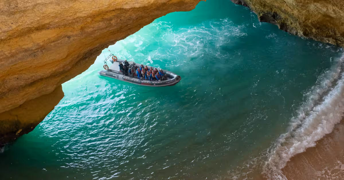 Speedboat approaching the iconic dome opening of Benagil Cave from the sea.