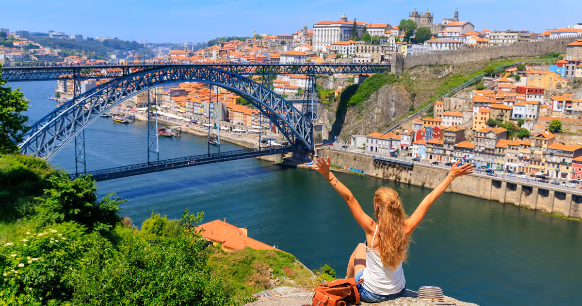 Golden sunset light over Porto rooftops with the Douro River below