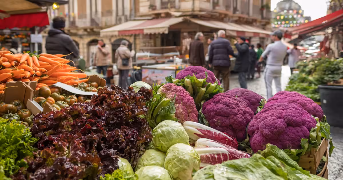 Bustling Palermo street market with colorful produce and local vendors.
