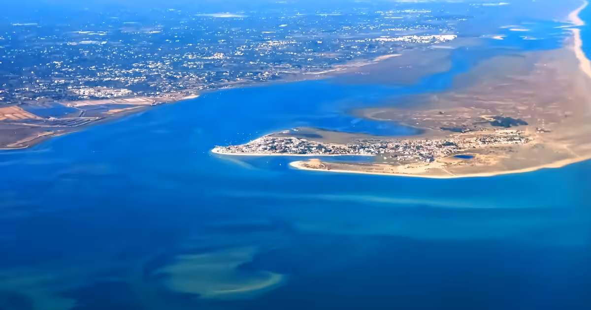 Turquoise lagoon channels and sandbanks of Ria Formosa Natural Park at low tide.