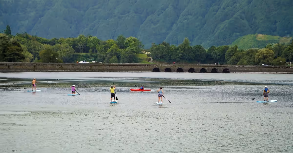 Kayaker paddling between the blue and green lakes of Sete Cidades caldera