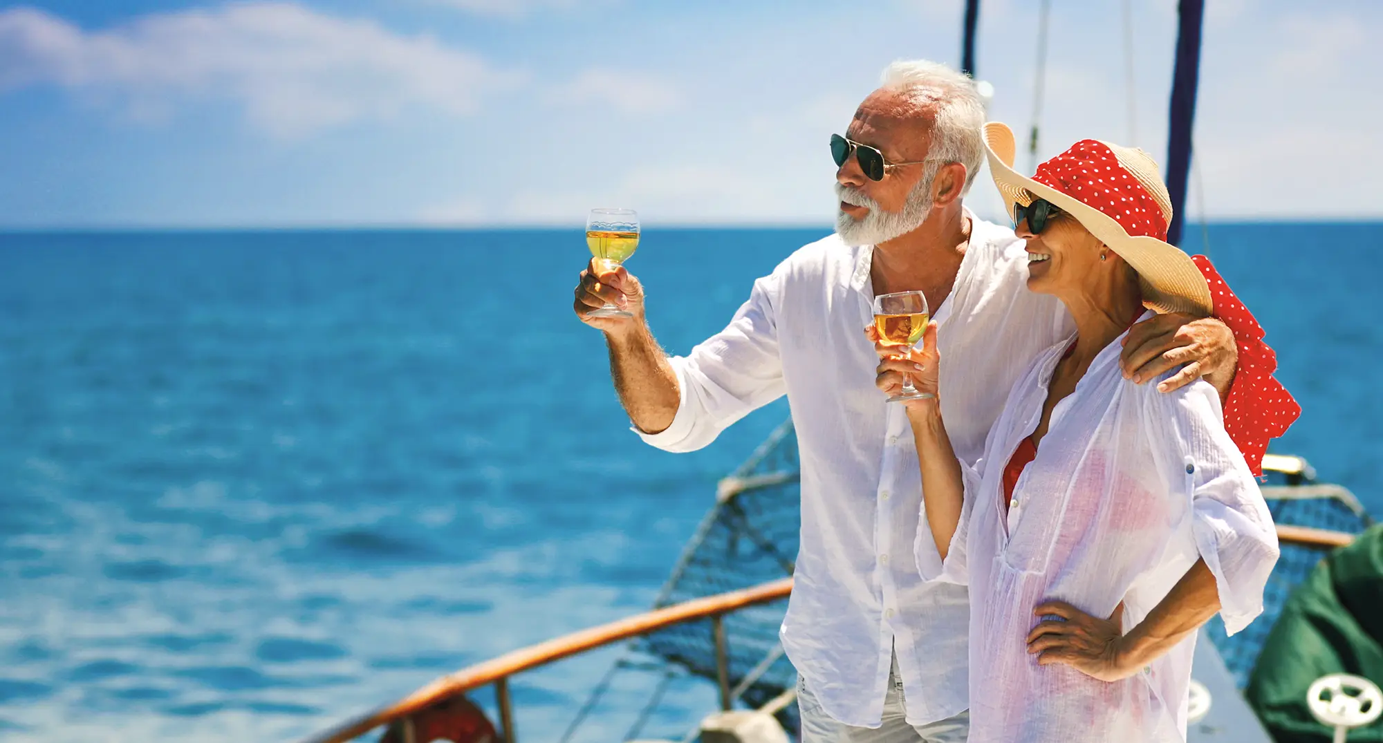 Passengers relaxing on a private luxury yacht anchored in a calm Algarve cove.