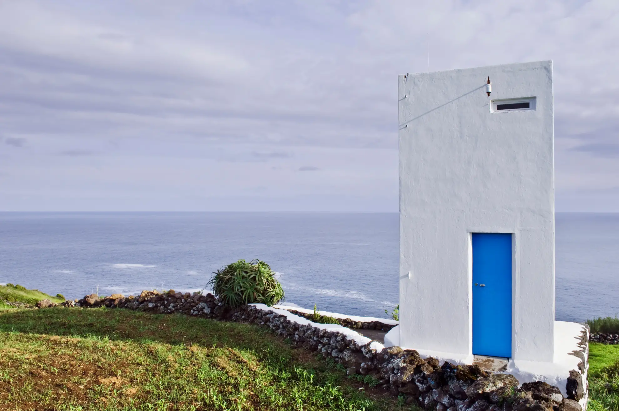 Vigia lookout spotter scanning Atlantic waters from a stone hut in the Azores