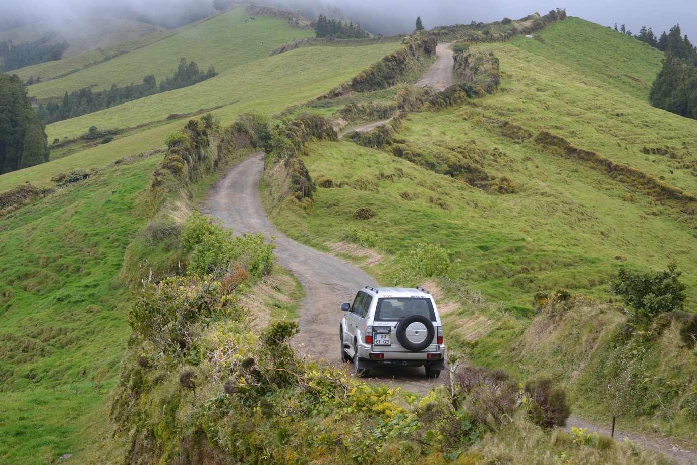 Aerial view of a jeep on a green ridge above Nordeste in northeastern S&atilde;o Miguel Azores